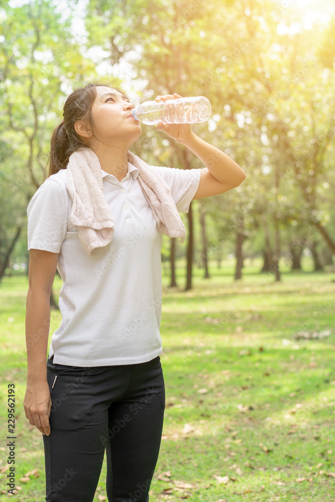 sporty man thirsty and drinking water after tired from jogging or exercise. sporty man thirsty and drinking water after tired from jogging or exercise.