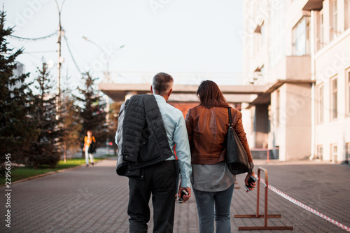 People walk in streets of at sunset