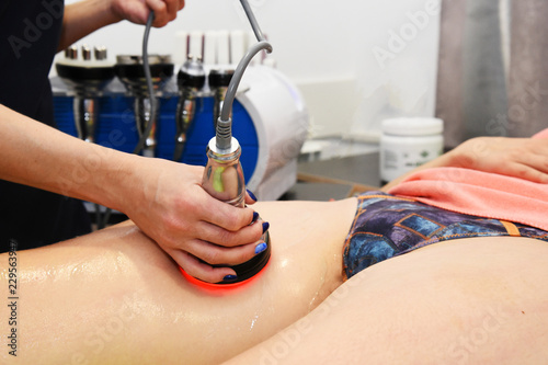 Rf skin tightening, belly. Hardware cosmetology. Body care. Non surgical body sculpting. Ultrasound cavitation body contouring treatment, anti-cellulite and anti-fat therapy in beauty salon. photo