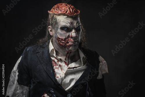 Scary zombie prostheric makeup on male model