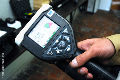 Dosimetrist holding a handheld radiation isotope identifier