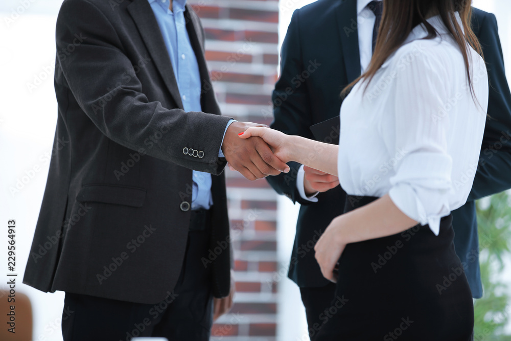 closeup .business handshake financial partners on the background of the office
