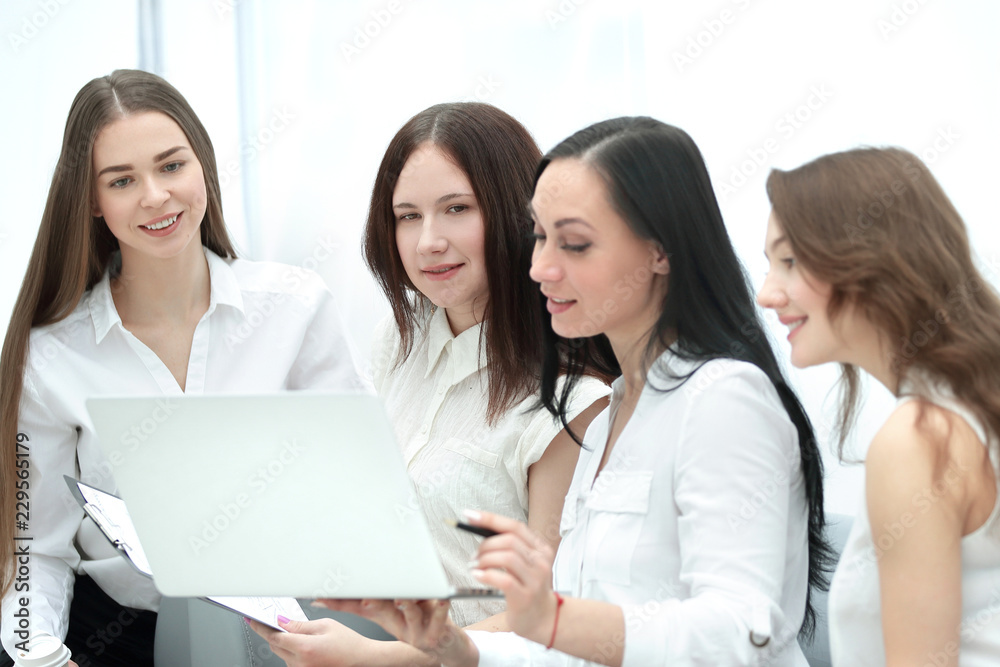 group of employees using laptop to check financial data group of employees using laptop to check financial data