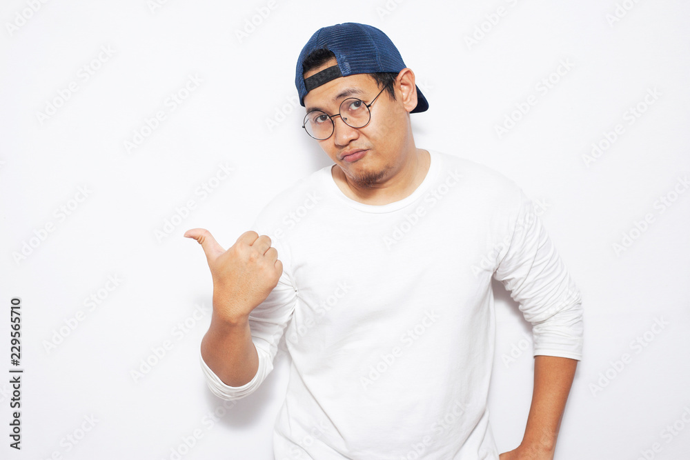 Young Man Showing and Pointing Something on His Side Young Man Showing and Pointing Something on His Side