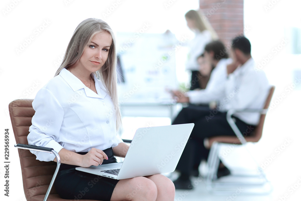 Executive business woman with a laptop on blurred background Executive business woman with a laptop on blurred background