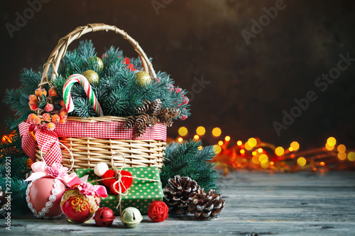 Merry Christmas and happy new year. Basket with Christmas toys and Christmas gifts on a wooden background.