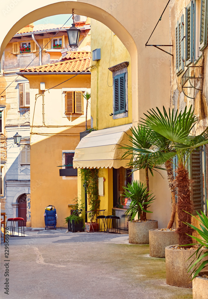 Lovran, Croatia. Cosy streets of ancient old town with arc.