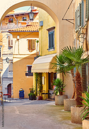 Lovran, Croatia. Cosy streets of ancient old town with arc. © Yasonya