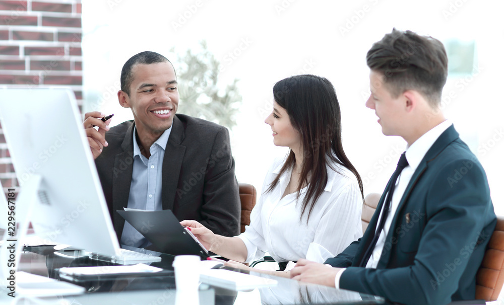 business team working together at desk in creative office business team working together at desk in creative office