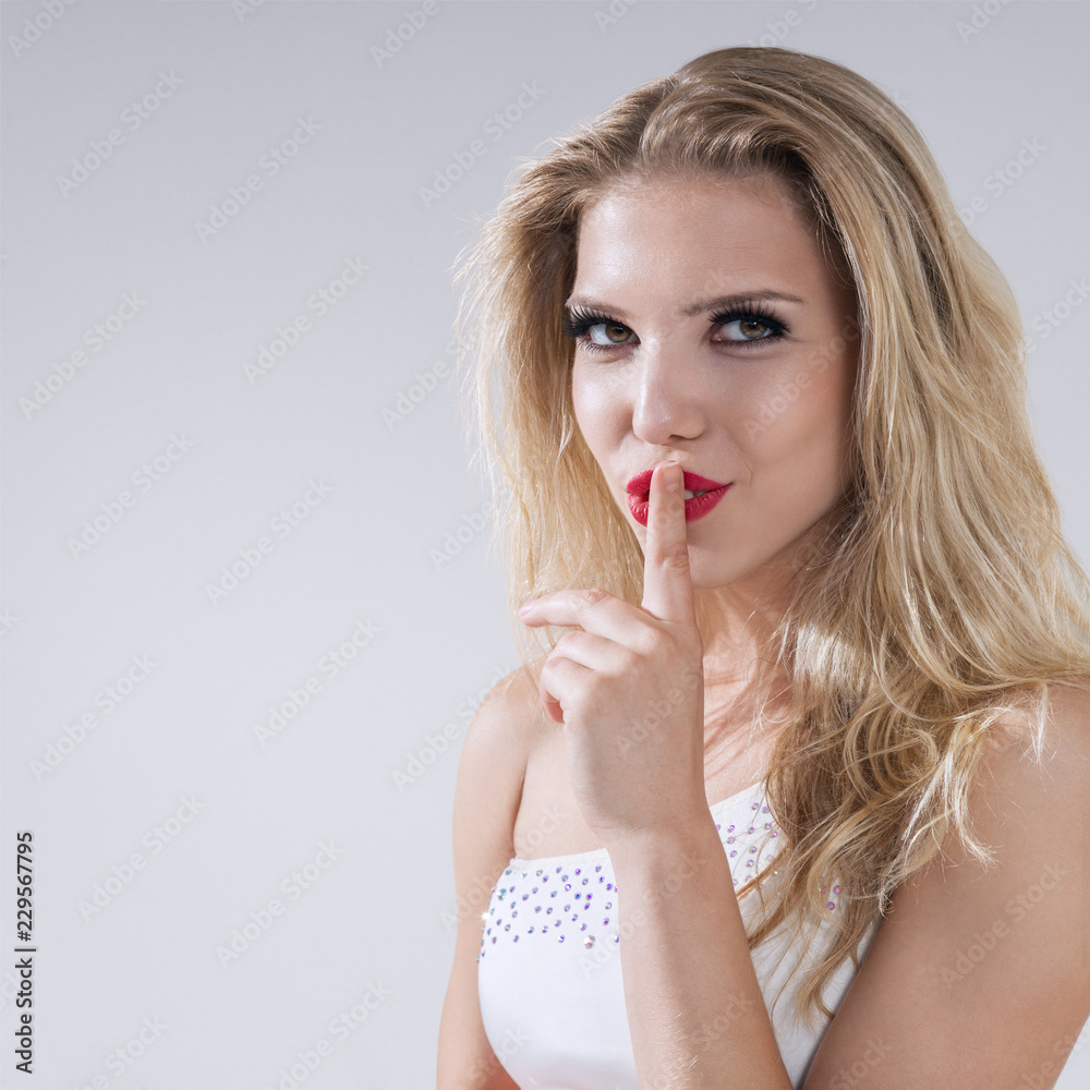 Fototapeta premium Young woman making a shushing gesture