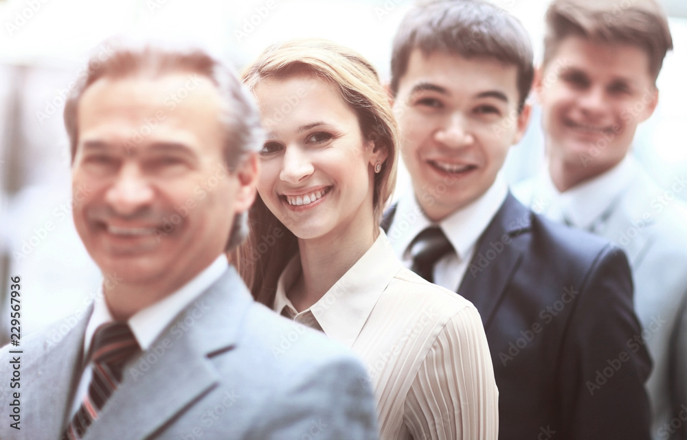 Happy smiling business team standing in a row at office Happy smiling business team standing in a row at office