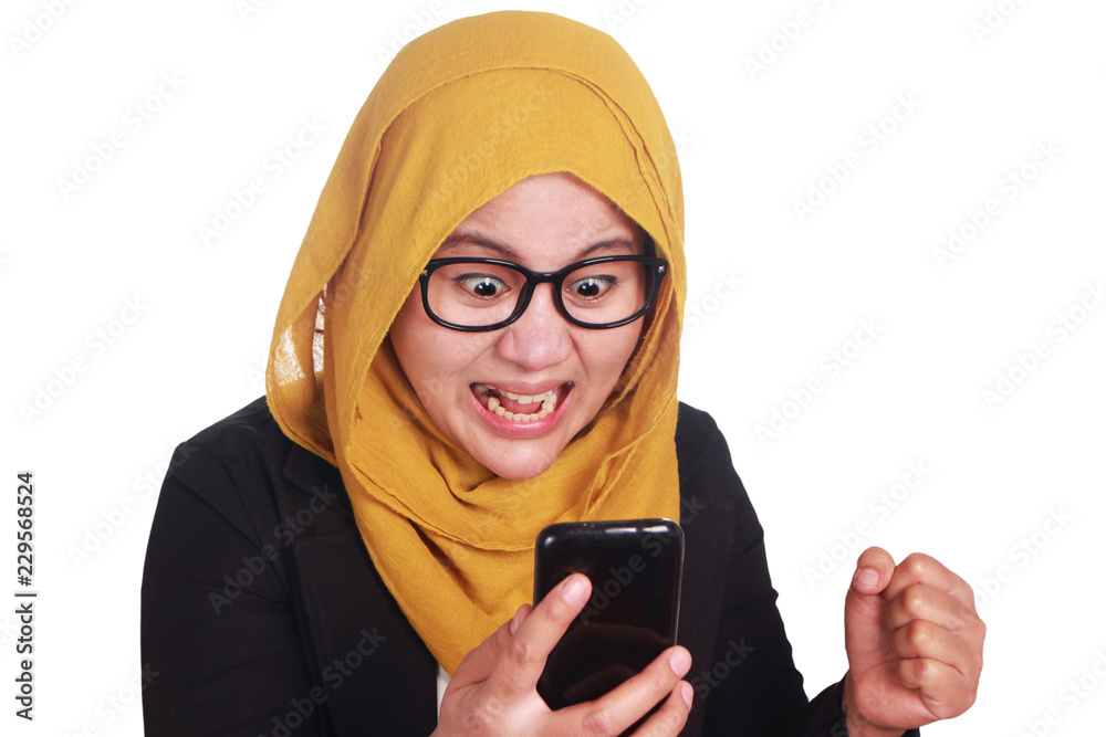 Muslim Woman Angry While Reading Text Message on Smart Phone Muslim Woman Angry While Reading Text Message on Smart Phone