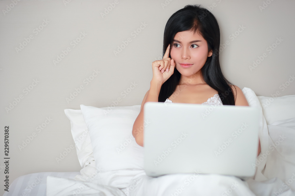 beautiful and sexy woman using laptop computer on bed before fall asleep beautiful and sexy woman using laptop computer on bed before fall asleep