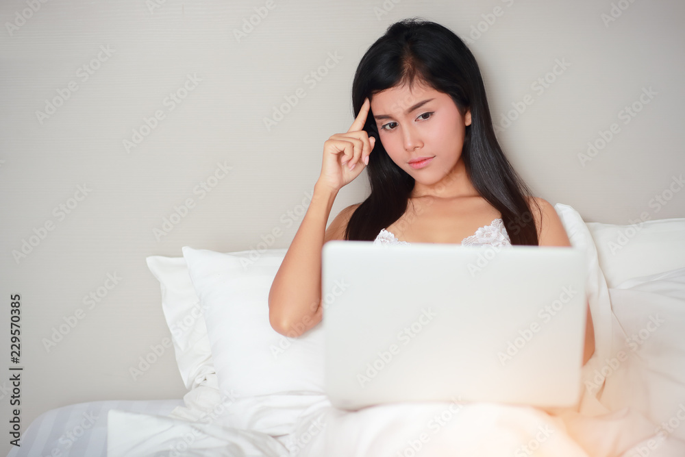 beautiful and sexy woman using laptop computer on bed before fall asleep beautiful and sexy woman using laptop computer on bed before fall asleep