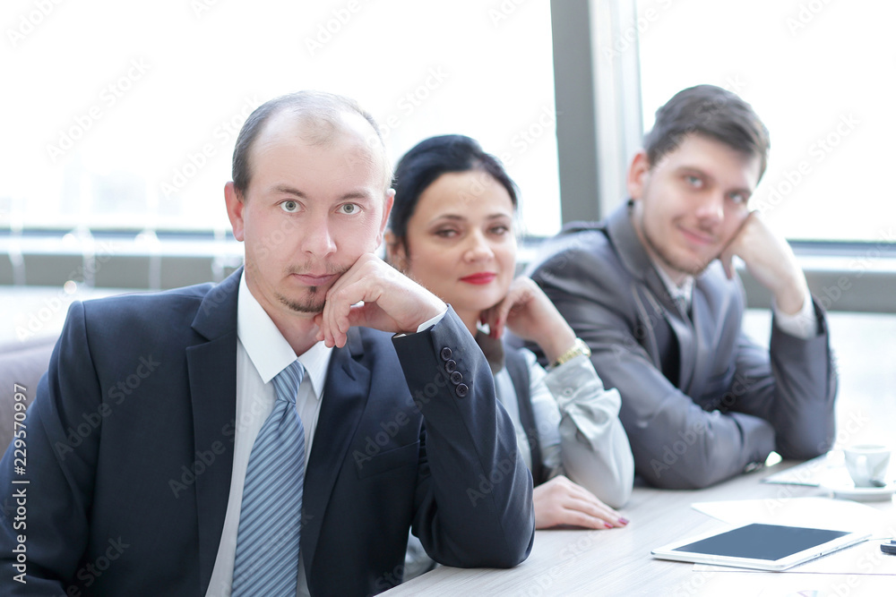 close up.business team sitting at their Desk close up.business team sitting at their Desk