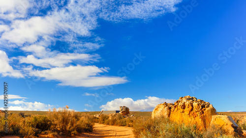 Autumn landscape with a dirt road and interesting rocks the kagga Kamma nature reserve photo