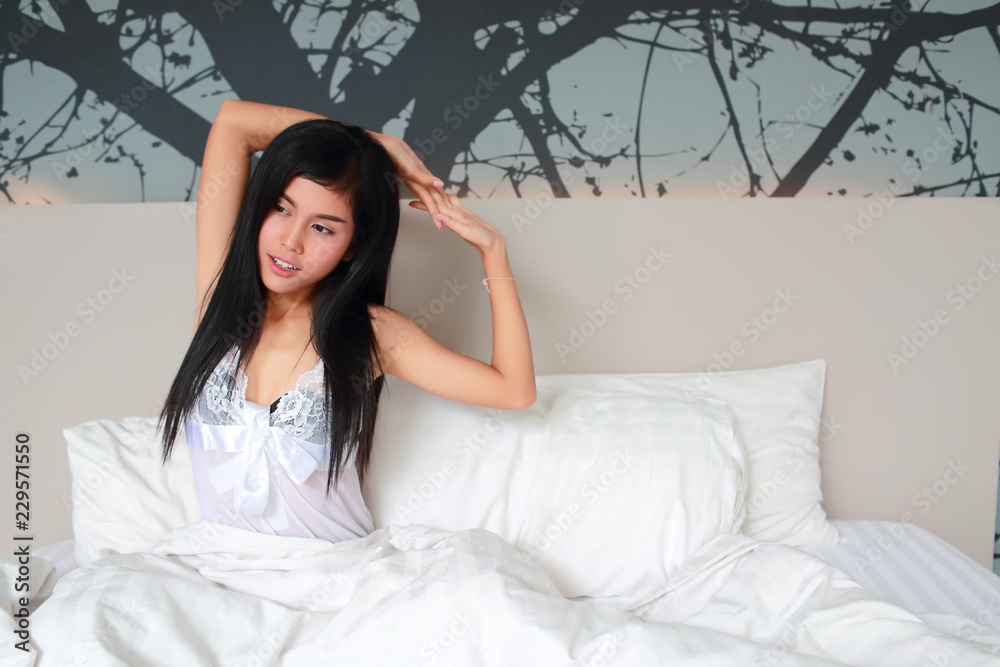 young beautiful and sexy woman lie down and stretch oneself on bedroom young beautiful and sexy woman lie down and stretch oneself on bedroom
