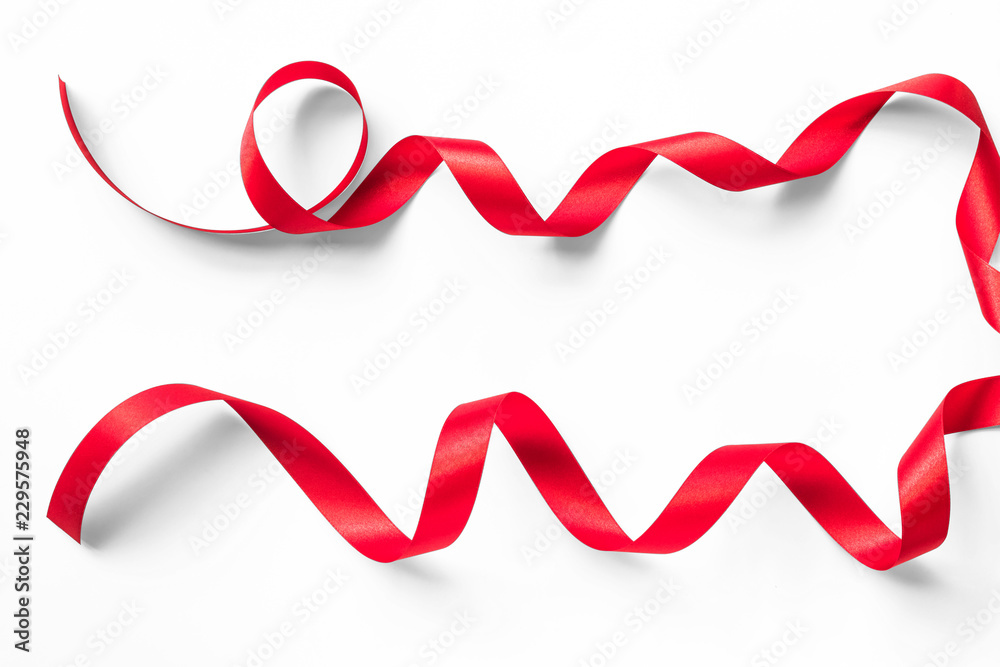 Red satin ribbon curly bow color isolated on white background with clipping path for Christmas holiday greeting card design decoration element Red satin ribbon curly bow color isolated on white background with clipping path for Christmas holiday greeting card design decoration element