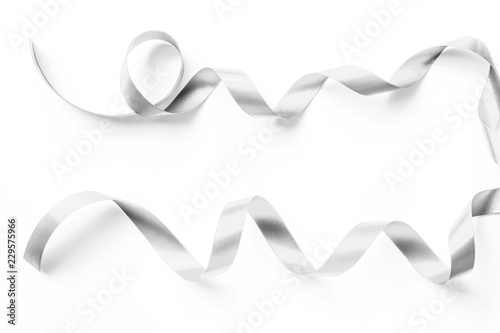 Silver satin ribbon in bright white pearl gray color isolated on white background with clipping path © Chinnapong