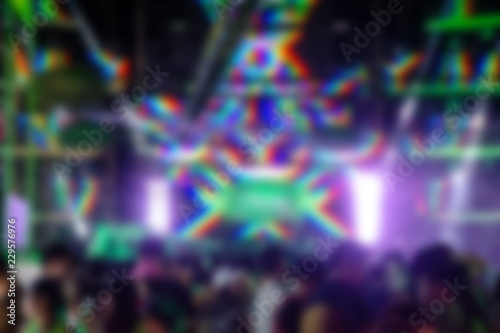 blurred night club party festival with crowd of people for background