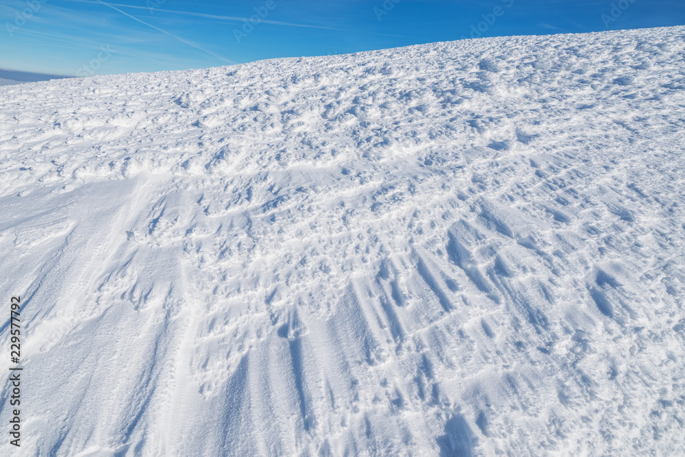 Fresh sparkling snow cover on mountain tops. Blue sky at the background. Fresh sparkling snow cover on mountain tops. Blue sky at the background.