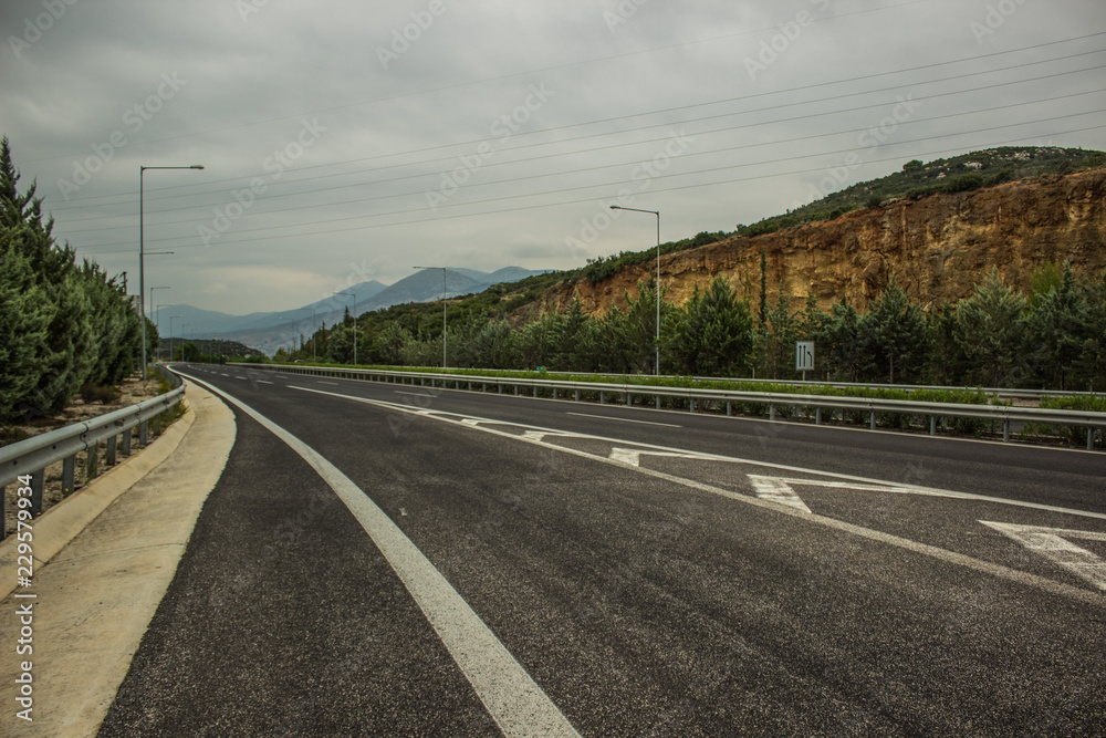 industrial and transport concept of empty free European highway between mountains scenery landscape in cloudy and rainy weather