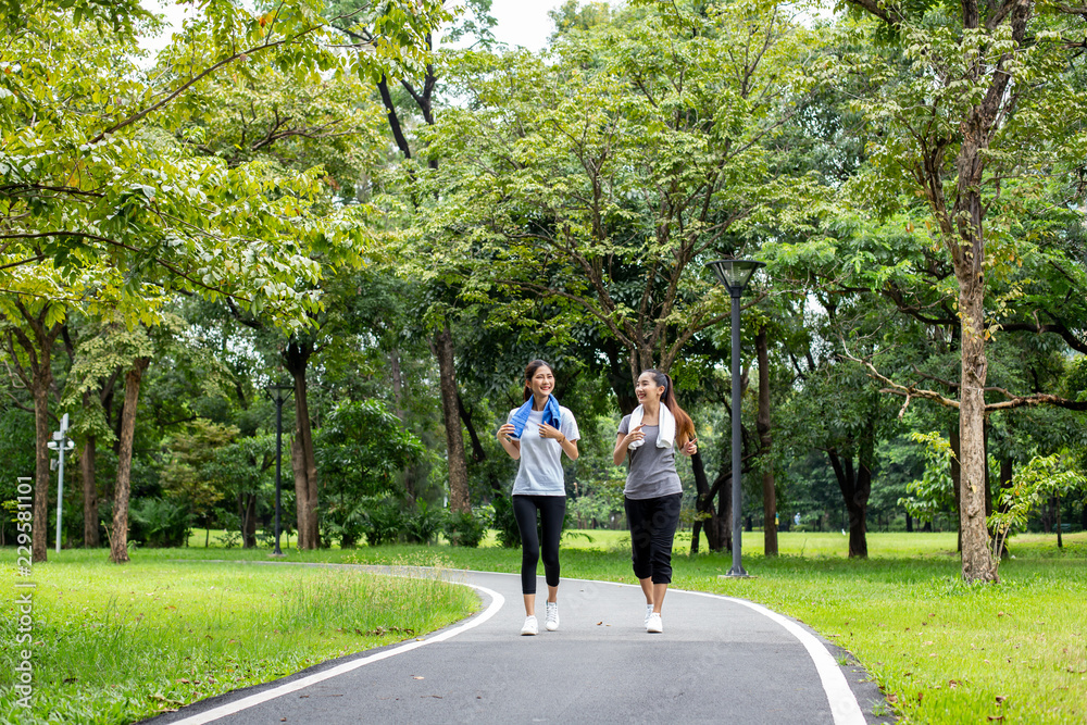 Woman running with friend at garden. Women resting at garden together in holiday. People with lifestyle, relax, holiday concept. Woman running with friend at garden. Women resting at garden together in holiday. People with lifestyle, relax, holiday concept.