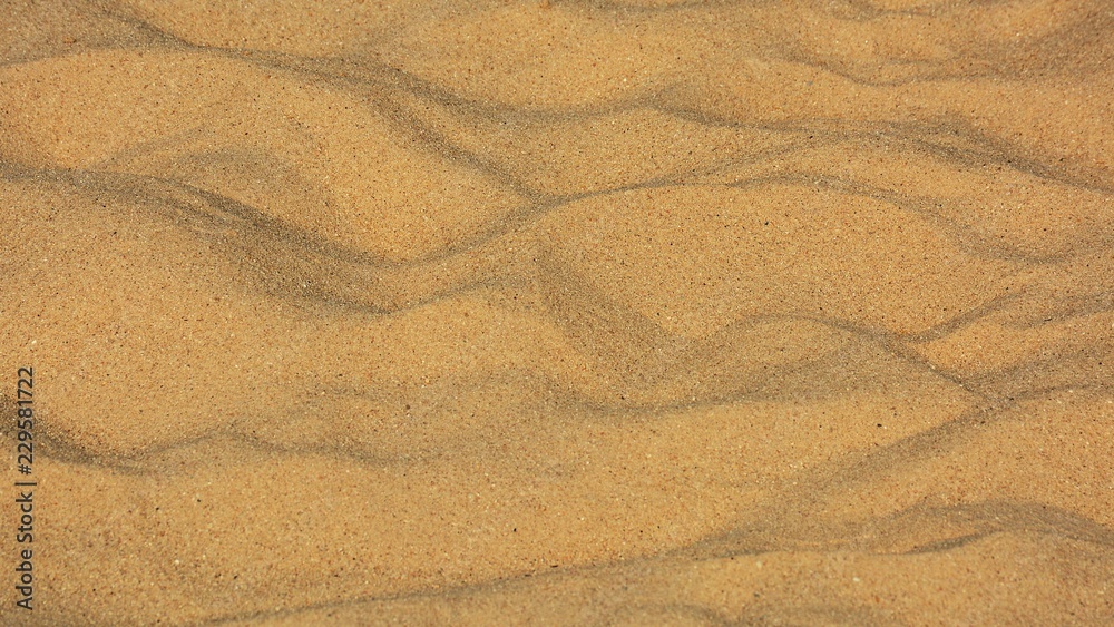 closeup of sand pattern of a beach in the summer closeup of sand pattern of a beach in the summer