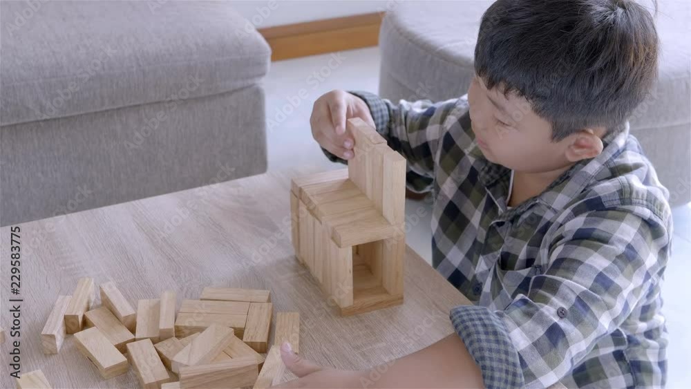 Asian children boy playing with wooden blocks game at home. Asian children boy playing with wooden blocks game at home.