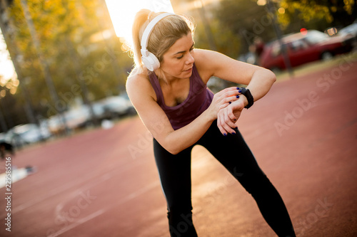 Young fitness woman looking...