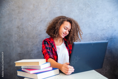 Curly hair teen girl workin...