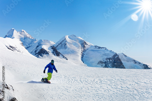 Winter snowboarding activity on sunny day in Alps