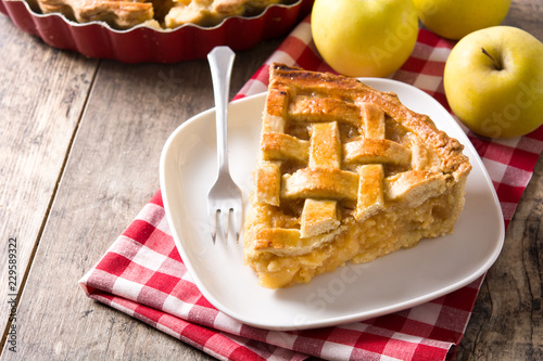 Homemade apple pie slice on wooden table