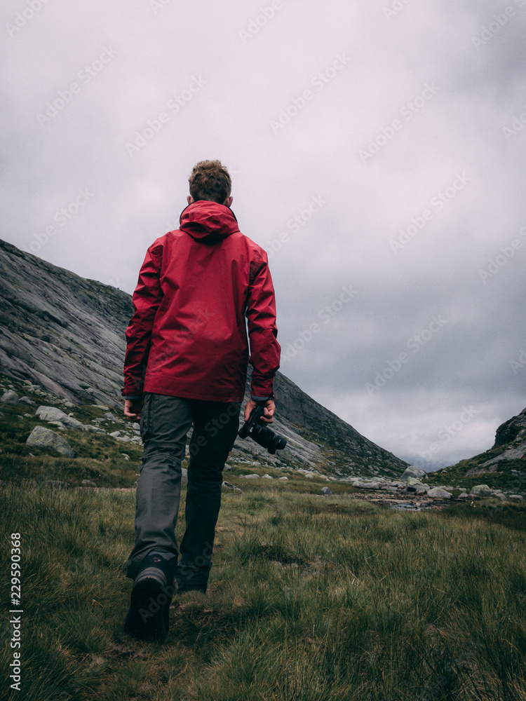Man in red jacket hiking in Nature
