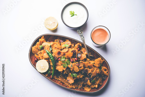 Homemade Kothu Parotta/ Paratha or Stir Fried Leftover Chapati Masala or  fodnichi poli in marathi, served in a bowl or plate with curd and hot tea. Selective focus photo