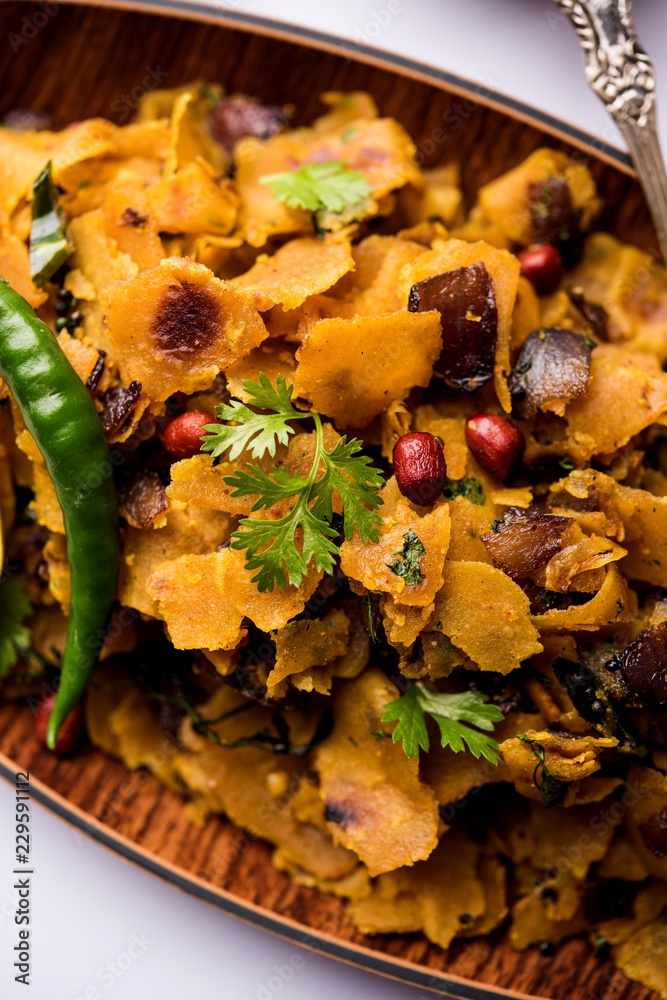 Fototapeta premium Homemade Kothu Parotta/ Paratha or Stir Fried Leftover Chapati Masala or fodnichi poli in marathi, served in a bowl or plate with curd and hot tea. Selective focus