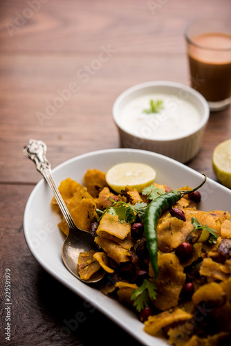 Homemade Kothu Parotta/ Paratha or Stir Fried Leftover Chapati Masala or fodnichi poli in marathi, served in a bowl or plate with curd and hot tea. Selective focus
