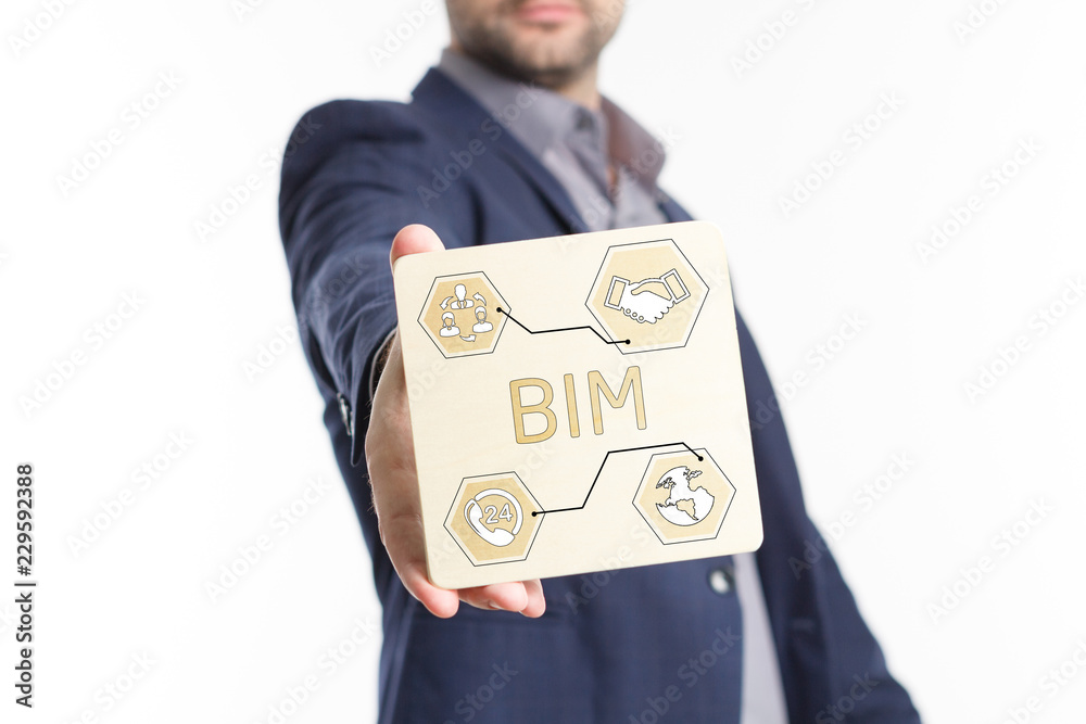 The concept of business, technology, the Internet and the network. Young businessman showing inscription: BIM The concept of business, technology, the Internet and the network. Young businessman showing inscription: BIM