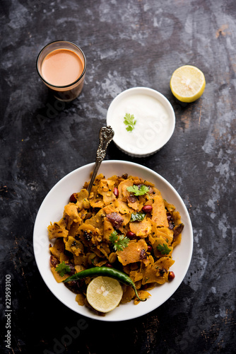 Homemade Kothu Parotta/ Paratha or Stir Fried Leftover Chapati Masala or  fodnichi poli in marathi, served in a bowl or plate with curd and hot tea. Selective focus