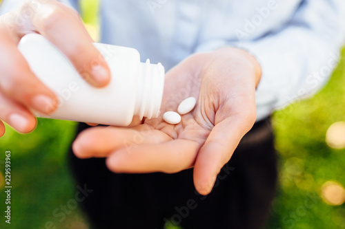 hands holding a jar with pills  closeup