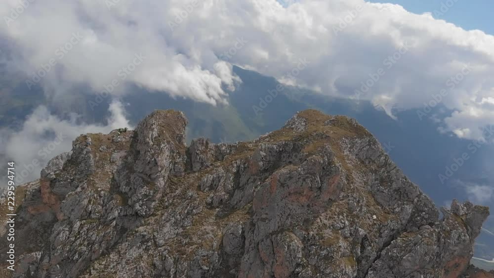 Aerial shot of climbers on top of a mountain high above the clouds. Aerial shot of climbers on top of a mountain high above the clouds.