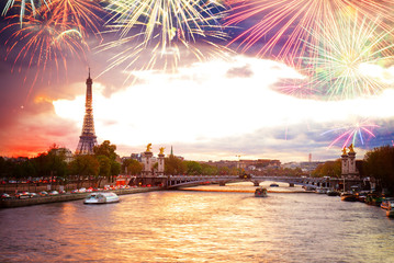 Alexandre III Bridge and Eiffel tower at sunset with fireworks, Paris, France