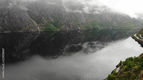 Norwegian landscape. Mountains and fjord Eidfjorden on overcast hazy weather photo