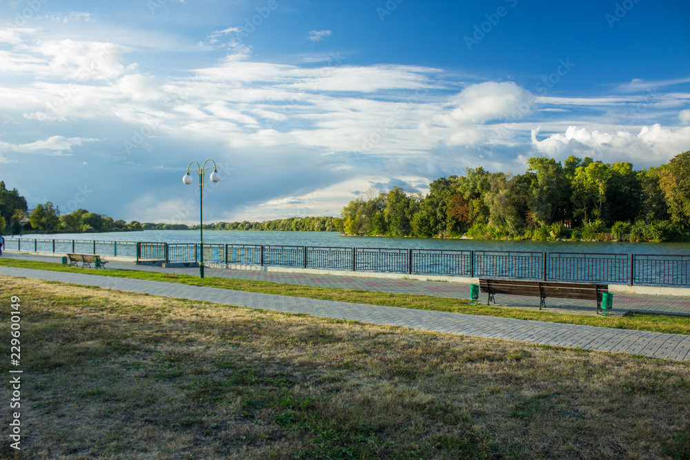 landscape exterior design concept of colorful walking waterfront river shore district with paved road, water surface and blue sky