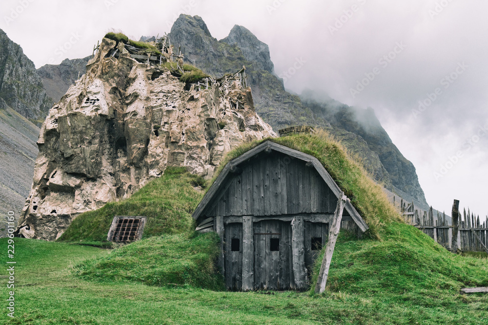 Traditional antique Viking village. Old wooden houses near Vestrahorn mountains on the Stokksnes Peninsula, Hofn, Iceland. Popular tourist attraction.