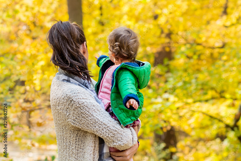 Happy Mother Hugging her Baby Girl in the Autumn Park .Mother and Daughter .Happy Family, Mother with Little Child in the Nature Happy Mother Hugging her Baby Girl in the Autumn Park .Mother and Daughter .Happy Family, Mother with Little Child in the Nature