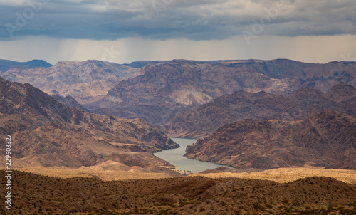 Colorado River in valley of barren desert landscape