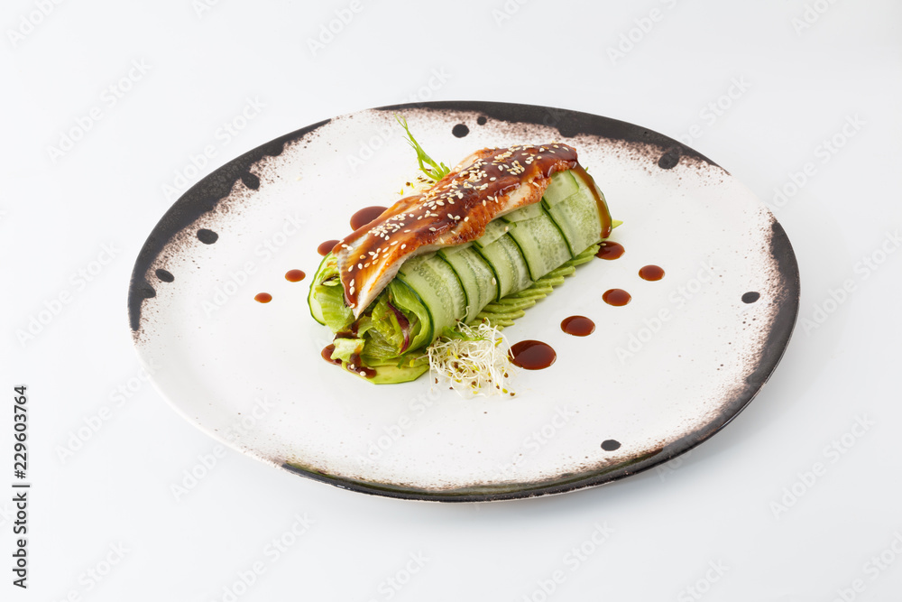 cucumber salad roll with acne in a white plate isolated on white background cucumber salad roll with acne in a white plate isolated on white background