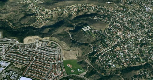 Very high-altitude circular tracking shot of a small city green belt. Reversible, seamless loop.   photo