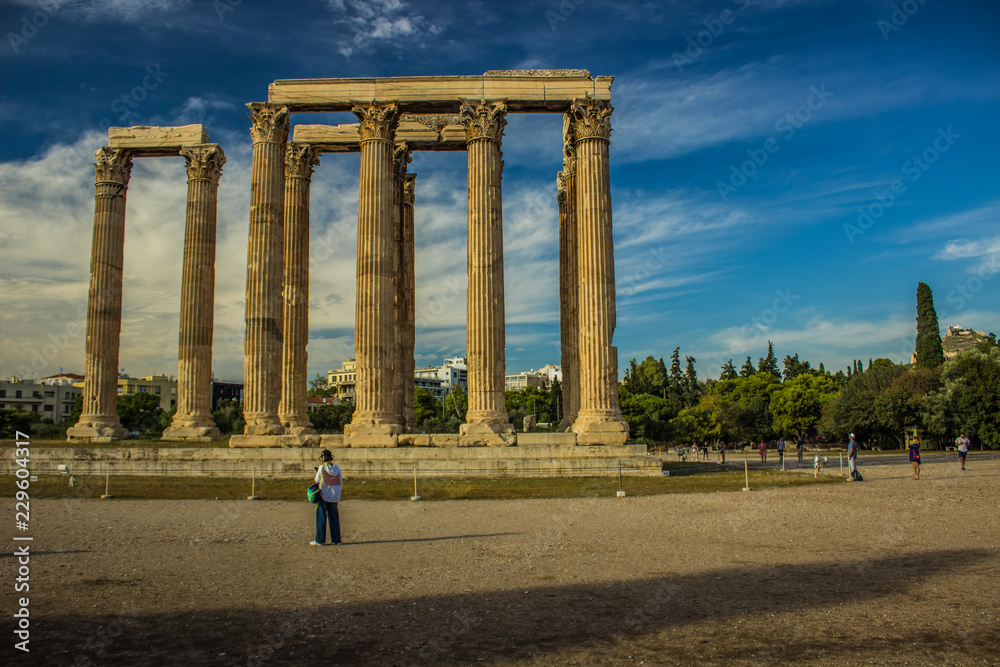 touristic concept of ancient Greece ruins of Temple with marble columns in museum area on contrast colorful blue sky background, copy space